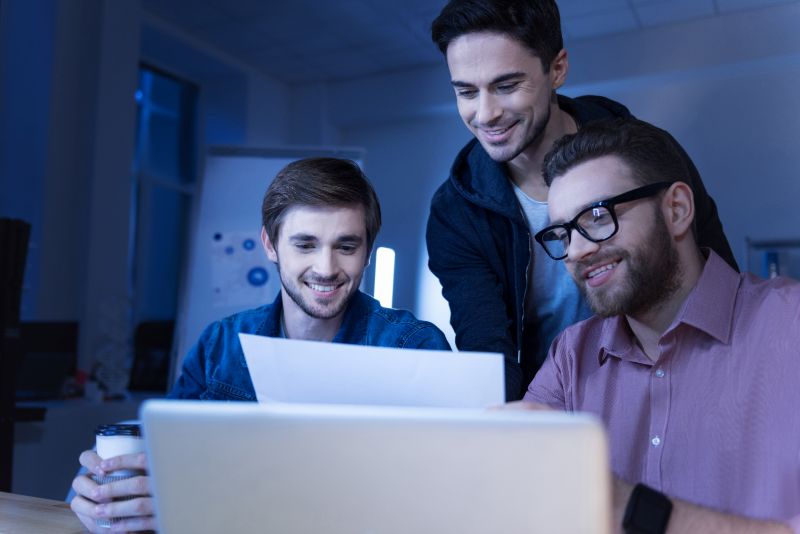 A Microsoft Power Apps use case showing a team reviewing documents and collaborating in an office setting.