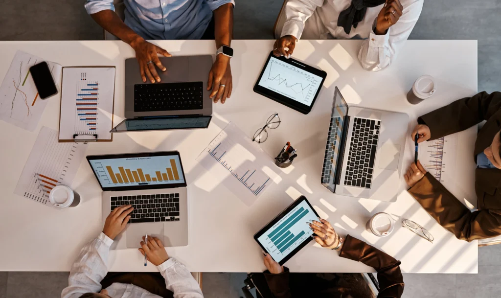 Marketing and IT leaders analyzing CRM performance data to address CRM adoption barriers and implementation challenges.