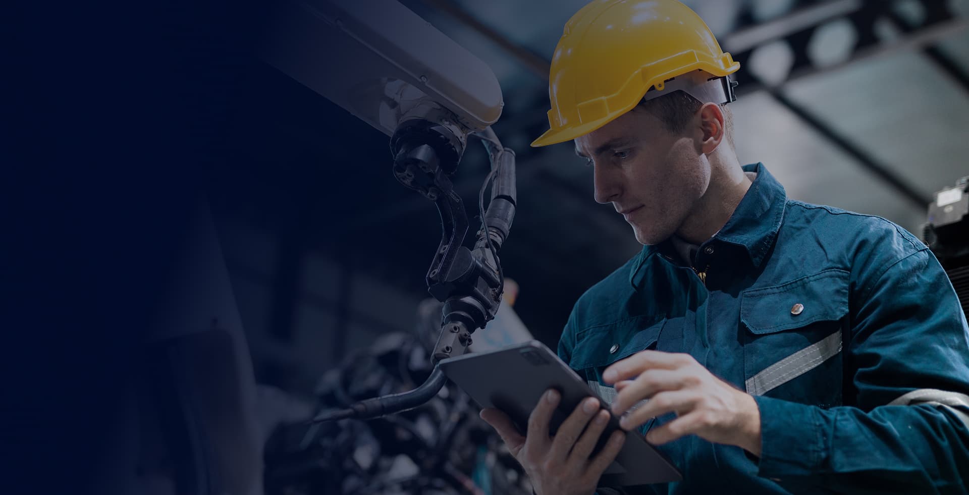 Manufacturing technician working with a robotic arm
